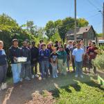 Prof. Kate Linnenberg and her sociology students do work in the community garden.